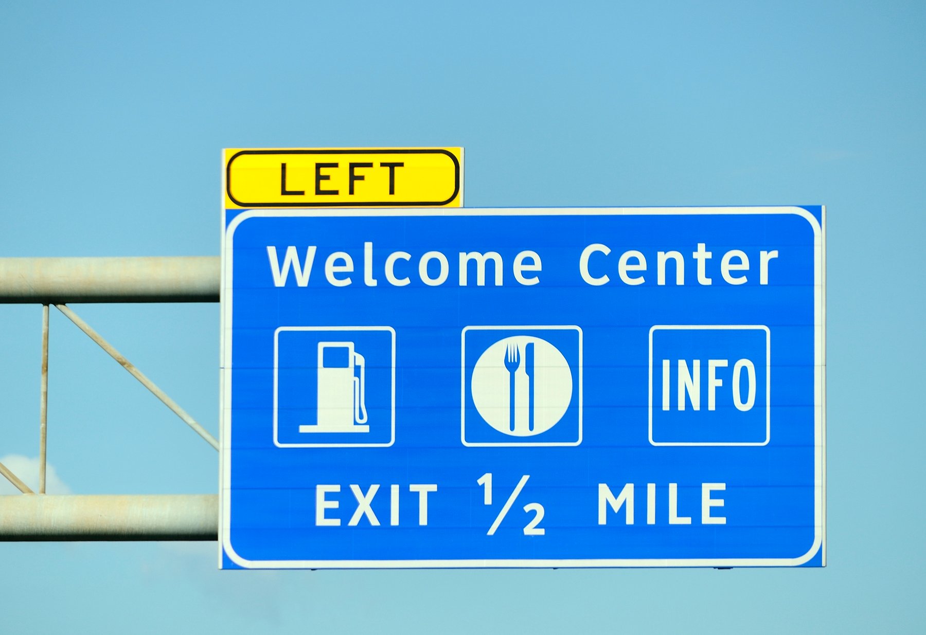 Highway sign for Welcome Center Exit.